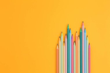 Sarı izole arkaplanda çok renkli kalemler