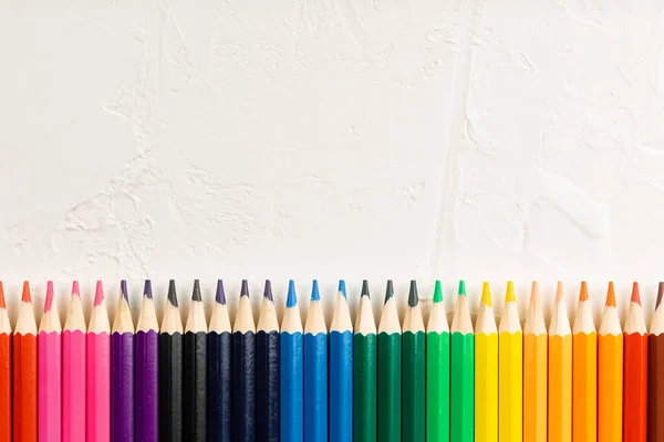 Colored pencils in row on a white background — Stock Photo, Image
