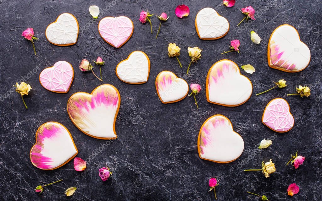 Decorated of Valentines. small heart shape cookies on dark wooden background. The idea of love!