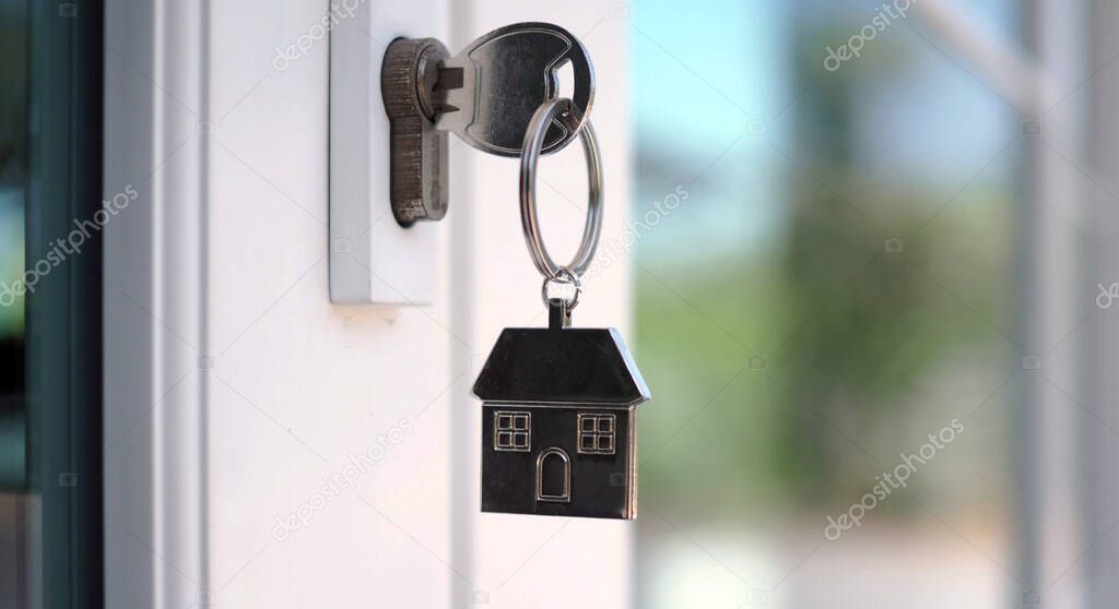 The house key for unlocking a new house is plugged into the door.