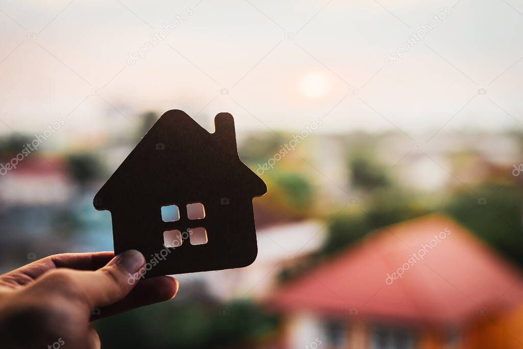 House model in home insurance broker agents hand or in salesman person.