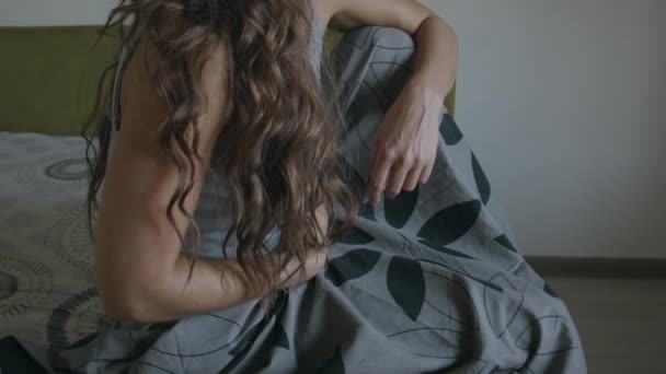Sad unhealthy young woman suffering from freezing, covering in blanket and swallows a pill. Millennial lady caught cold, treating herself alone at home. — Stock Footage Sad Unhealthy Young Woman Suffering Freezing Covering Blanket Swallows Pill Video Clip