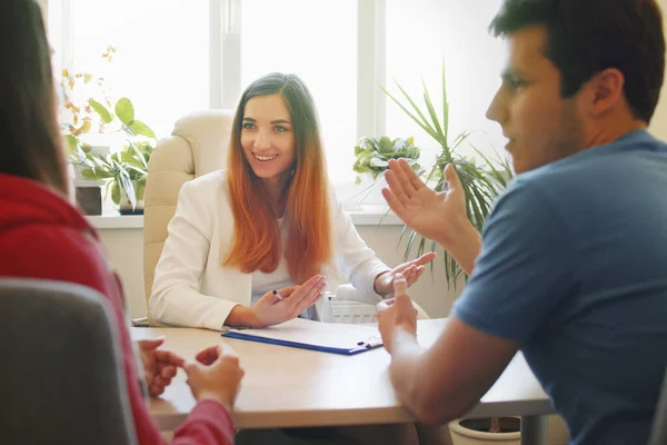 Woman psychologist talking to a young married couple