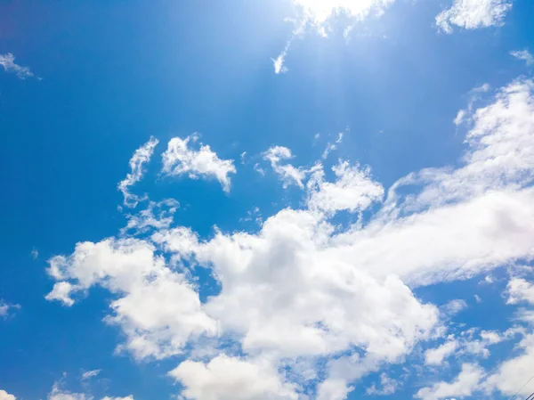 Blue sky and many white big clouds in daylight. Natural sky composition. Ideal for use in the design or wallpaper