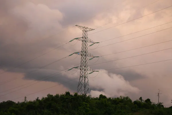 Electric post,High voltage pole of china on mountain in evening when sunset