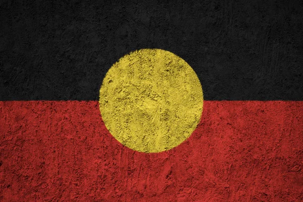 Painted flag of Australian Aboriginal on the concrete wall