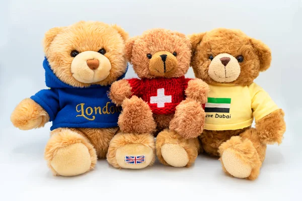 three funny teddy bear friends from different countries