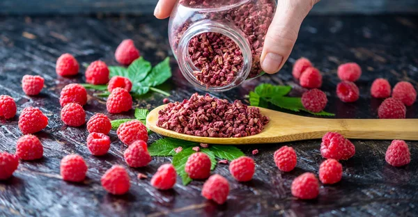 Hand Pouring Out Jar Freeze Dried Raspberries Wooden Spoon Concept — Stock Photo, Image