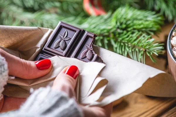 Girl Holding Chocolate Bar Wooden Table Which Lies Branch Christmas — Stock Photo, Image