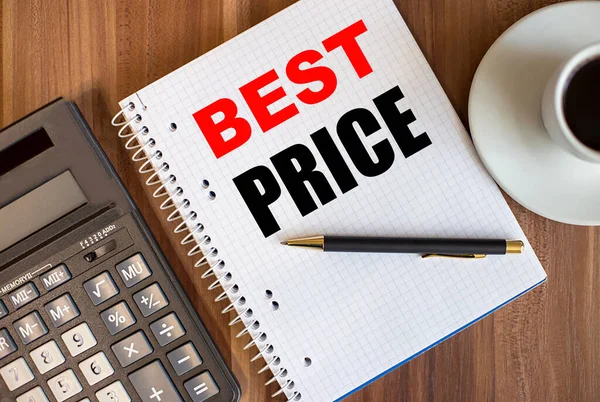 The best price is written in a white notebook on a wooden table near a calculator and coffee. Business concept