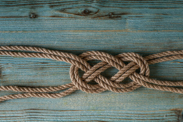beautiful nautical knot on a wooden blue shabby background