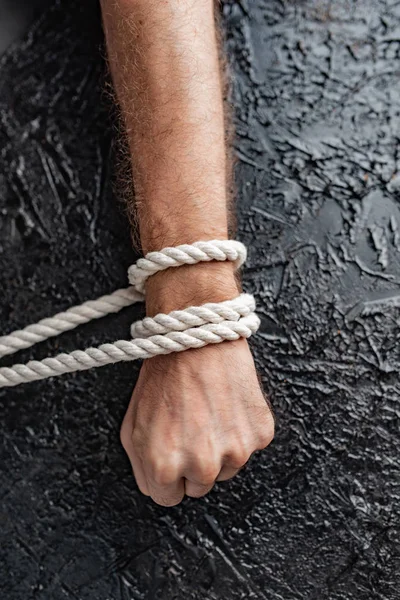 symbolism of human connection through hands and rope