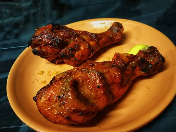 Tandoori Chicken Leg Pieces Placed Orange Plate Piece Lemon Black — Stock Photo, Image