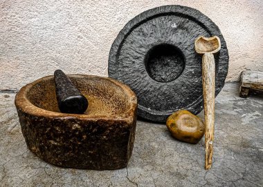 Ancient indian grinding and crushing tools made from stone with a wooden spoon. clipart