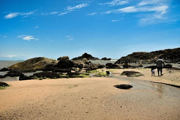 Om beach gokarna seascape with igneous rocks.