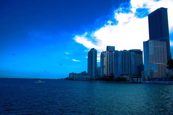 View of buildings next to the Miami South Channel in Brickell Miami, Florida with blue sky, Skyline of Brickell near the the Miami South Channel with dark blue sky, Sunny day in Brickell Miami