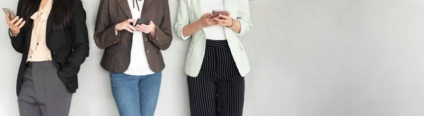 Cropped Image Group Young Businesswomen Using Smartphones While Standing Grey — Stock Photo, Image