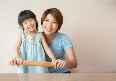 Mutlu anne ve çocuk renkli hamur hazırlanıyor.