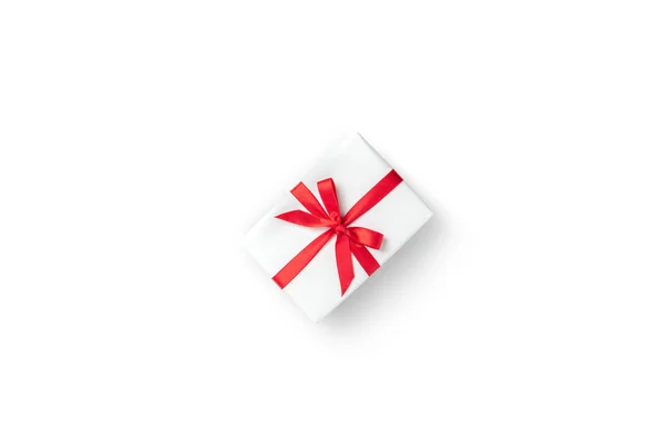 Top view of white gift box with red ribbon on white isolated bac — Stock Photo, Image