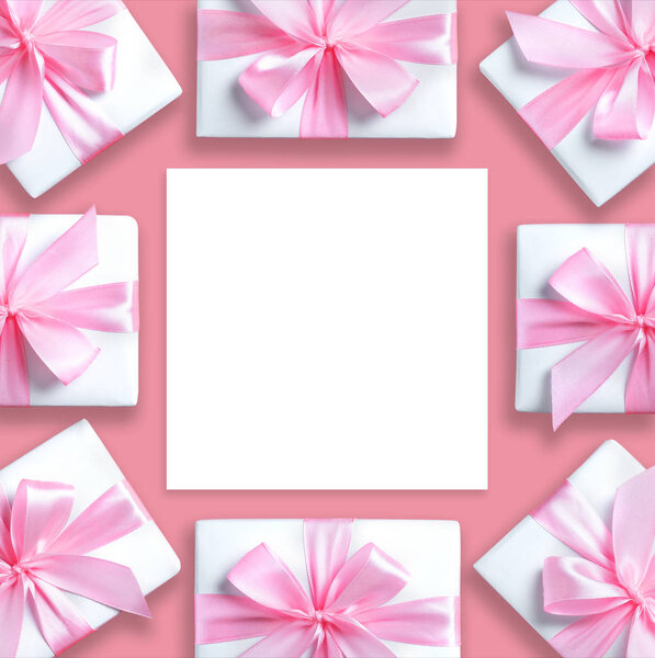 gift boxes and paper sheet on pink isolated background.