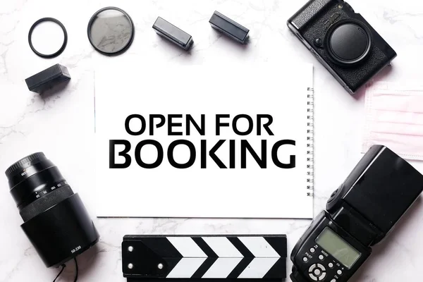 Camera gear with open for booking at drawing pad