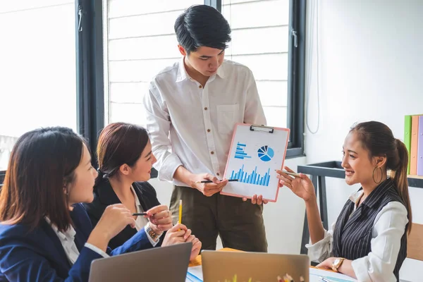 Young asian entrepreneur in business casual giving presentation to investors