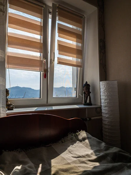 window in the room, sun room, figurine, floor lamp, sun, yellow blinds. Russia, city of Nakhodka, bay Nakhodka.