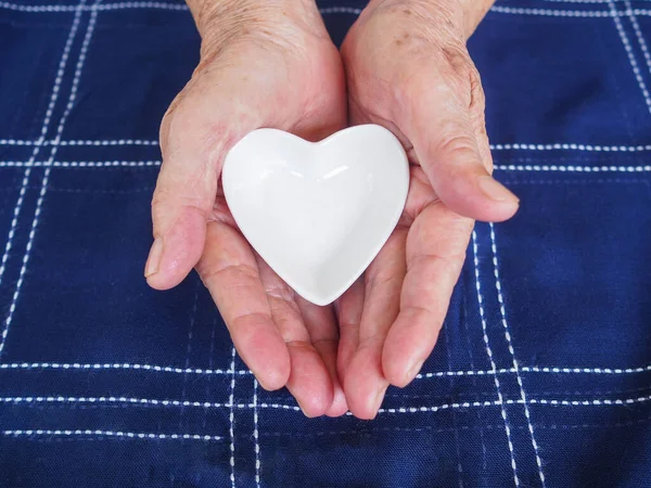 Close Partial View White Ceramic Heart Senior Woman Hands Love — Stock Photo, Image