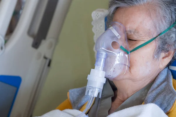 Close-up of elderly woman patients with lung disease, getting oxygen for treatment in the room at hospital. Space for text. Health care concept