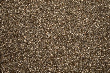 Arkaplan olarak güzel damarları olan oval siyah ve beyaz chia tohumları