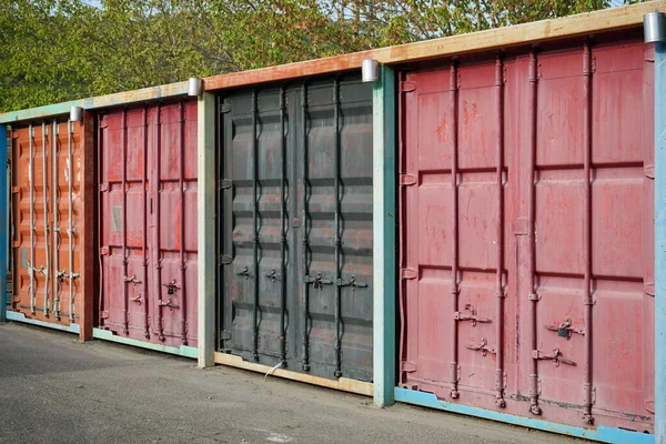 sea containers of different colors evenly exposed outside for use as storage facilities