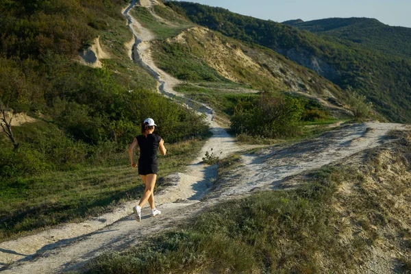 woman on a jogging trip in the mountains on the coast of the sea