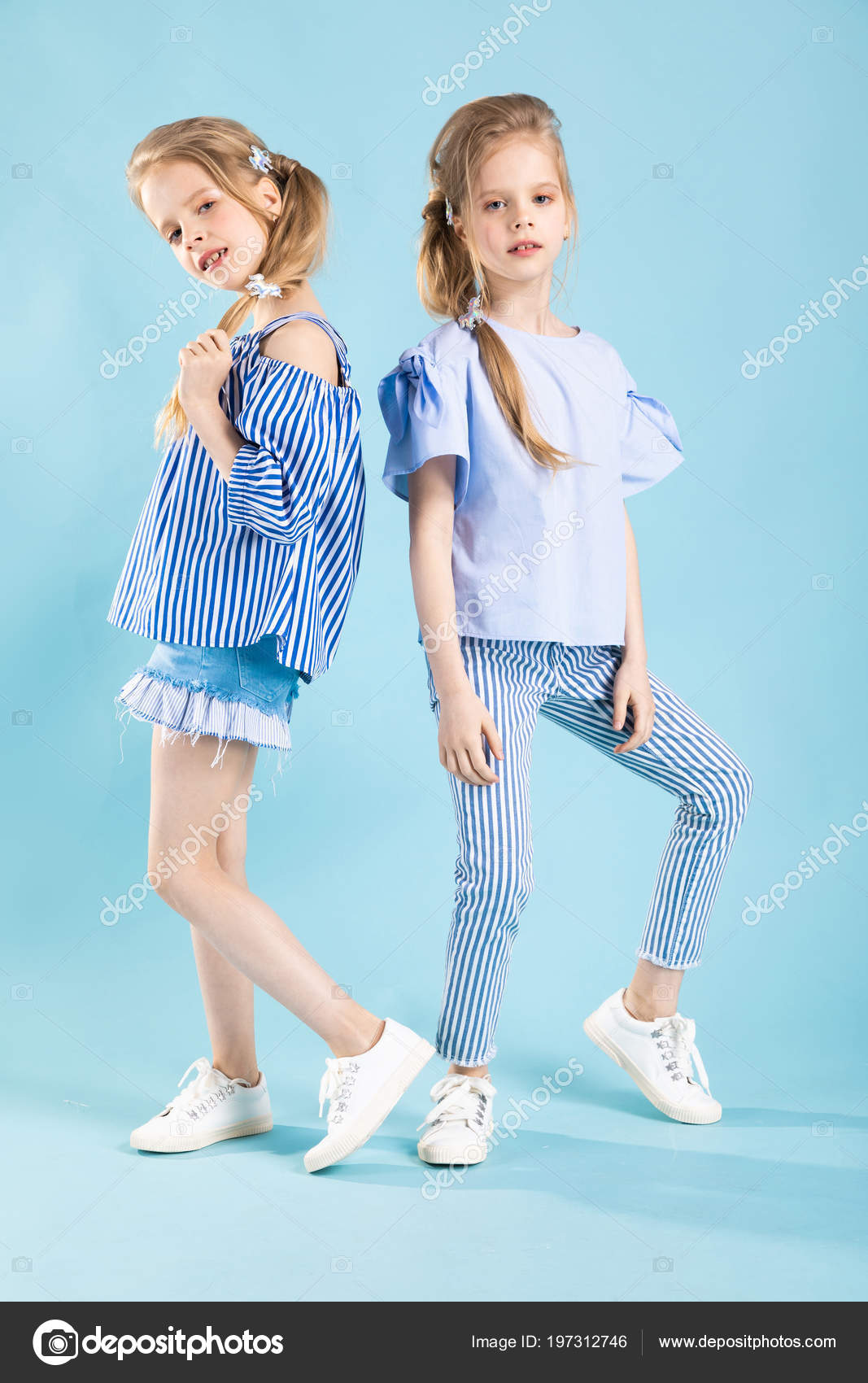Girls Twins In Light Blue Clothes Are Posing On A Blue Background Stock Photo By C Fotoevent Stock Girls Twins In Light Blue Clothes Are Posing On A Blue Background Stock Photo By C Fotoevent Stock