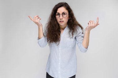 Gözlüklü genç esmer kız. Kız ellerini yanlara yaymak.