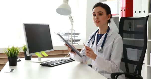 Female Doctor Showing Papers Looking Camera — Stock Video
