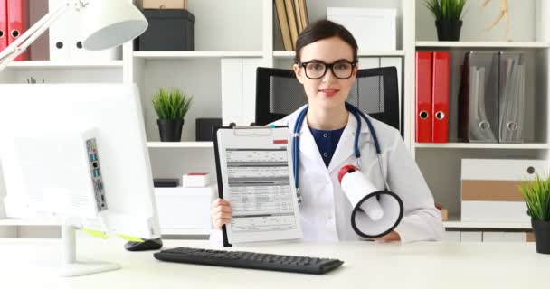 Doctor Speaking Loudspeaker Showing Documents While Office — Stock Video