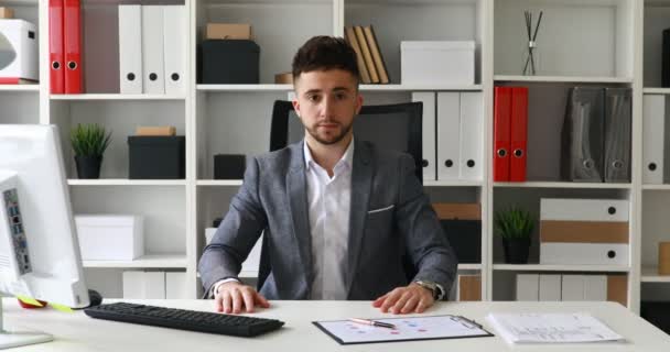 Geschäftsmann Arbeitsplatz Blickt Die Kamera — Stockvideo