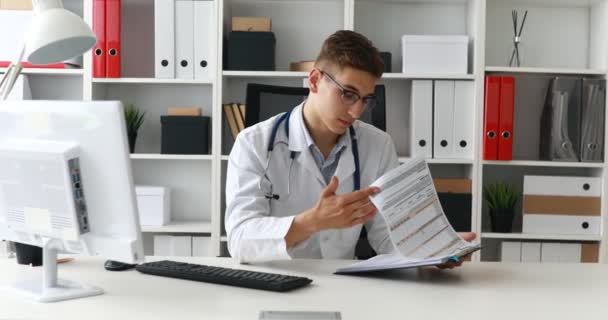Young Doctor Working Documents Taking Glasses — Stock Video