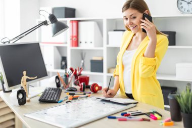 Genç bir kız bir masanın ayakta, telefonda konuşurken, onun elinde bir kalem tutan ve notları bir defterde yapma. Önce kız masanın üzerinde bir manyetik tahta