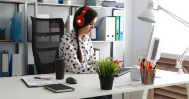 işkadını kırmızı kulaklık dizüstü bilgisayar kullanma modern office