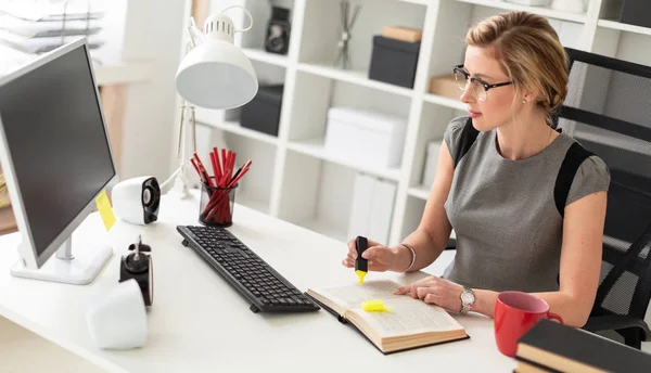 Genç bir kız, sarı bir işaret onun elinde tutan ofiste, bir masada oturuyor. Önce kız açık bir kitap yatıyor.