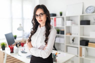 Güzel bir genç kız Ofis Masası göğsüne sıktı elleri duruyor..