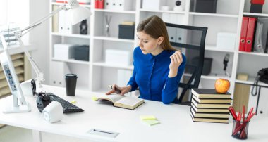 Genç bir kız bir bilgisayar masada oturur ve sarı bir işaret onun elinde tutar. Önce kız açık bir kitap yatıyor.