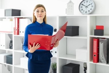 Genç bir kız belgili tanımlık sığınak yakınındaki ofiste anlamına gelir ve bir klasör belgeler ile onun elinde tutan.