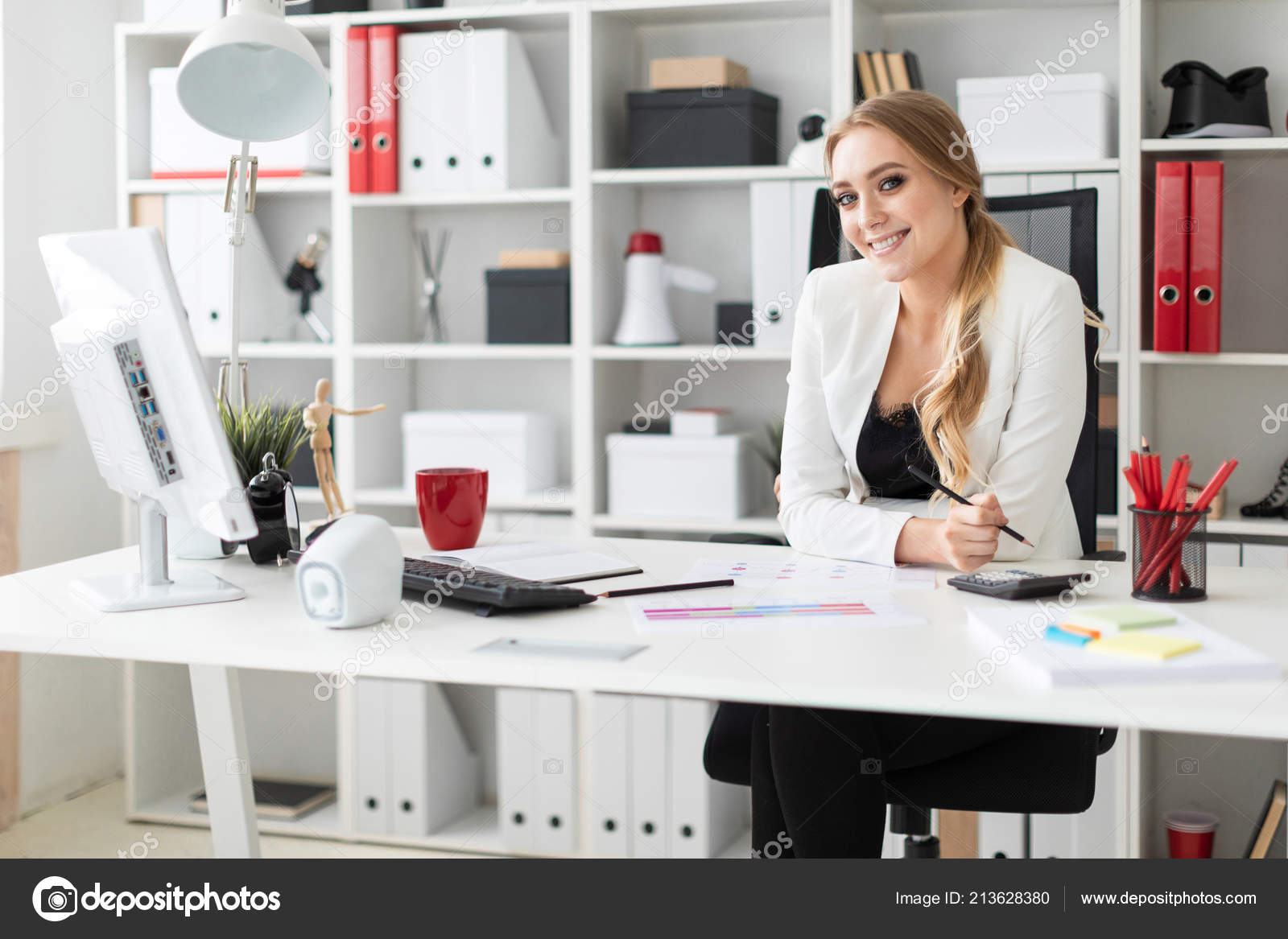 A Young Girl Is Sitting At The Computer Desk In Office