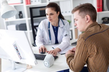 bilgisayarı kullanmak ve hastaya Office sorunu açıklayan beyaz önlük doktor