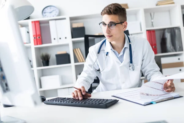 Junger Arzt Arbeitet Computer Während Mit Dokumenten Arbeitsplatz Büro Sitzt — Stockfoto