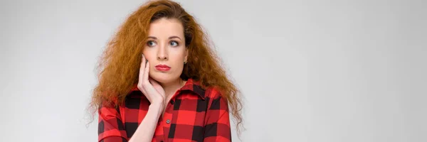 Retrato de hermosa pelirroja disgustada triste joven mujer sobre fondo gris — Foto de Stock