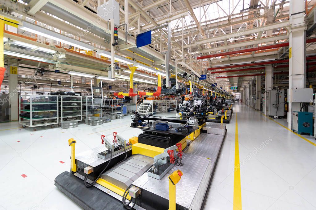 Transfer of car body. Robotic equipment makes Assembly of tcar. Modern car Assembly at factory