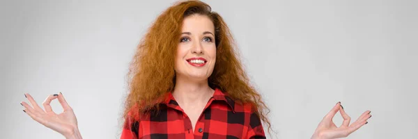 Young red-haired girl in a red checkered shirt. Young girl meditates — Stock Photo, Image